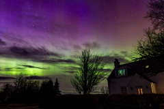 West Shinness cottage beneath a vivid aurora