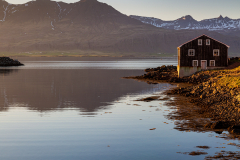 Wooden building in evening light by the harbour at Djúpivogur