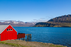 Red-painted building on the shore at Neskaupstaður