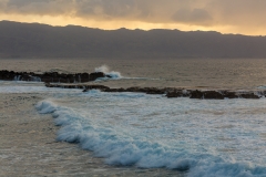 Waves roll in to Shark's Cove on Oahu's North Shore, bathed in e