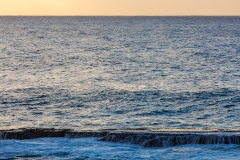 Waves roll in to Shark's Cove on Oahu's North Shore, bathed in e