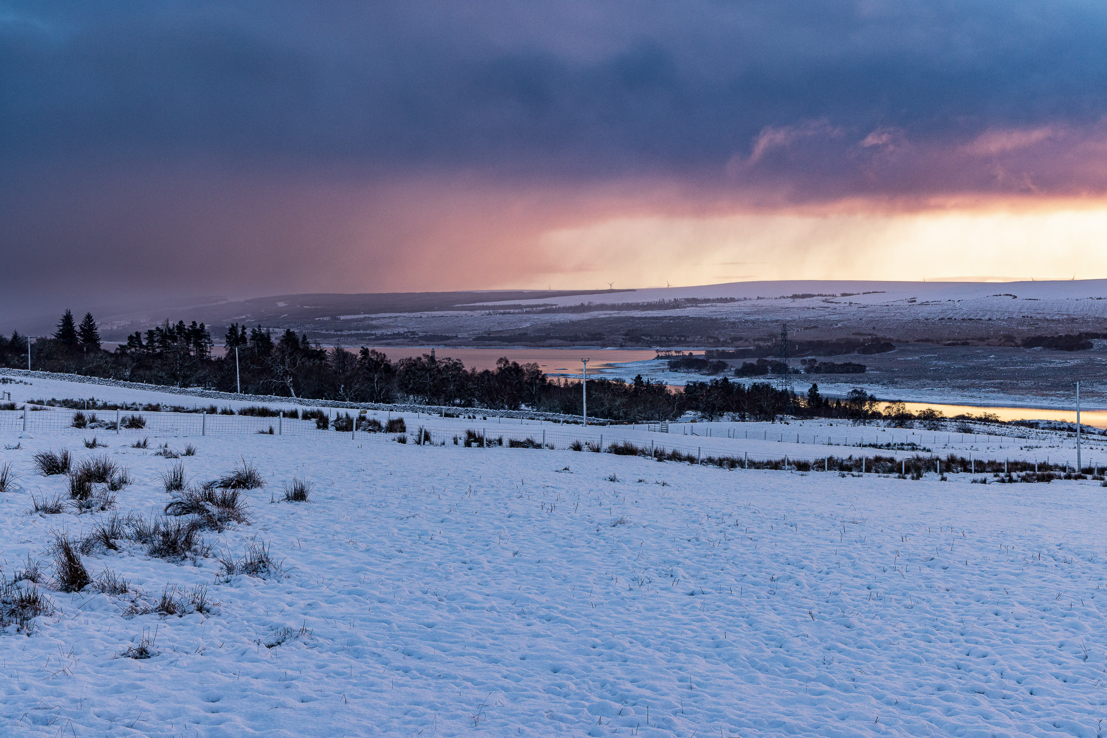 Snow showers at sunset over Loch Shin